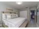 King-size bed, decorative pillows, and access to another room at 14004 Cascade Ln, Tampa, FL 33618