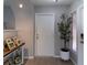 Entryway with white door, potted plant, and console table with framed photos at 14004 Cascade Ln, Tampa, FL 33618