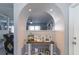 Bright entryway with decorative archway, console table, and Gathering photos at 14004 Cascade Ln, Tampa, FL 33618