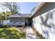 House exterior with walkway, landscaping, and a welcoming sign at 14004 Cascade Ln, Tampa, FL 33618