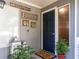 Navy blue front door with welcoming sign and potted plants at 14004 Cascade Ln, Tampa, FL 33618