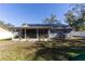 House exterior with solar panels and a screened porch at 14004 Cascade Ln, Tampa, FL 33618