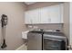 Laundry room with washer, dryer, and cabinets at 14639 Balloch Dr, Hudson, FL 34667