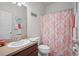 Bathroom with a single vanity and a coral shower curtain at 15439 Stone House Dr, Brooksville, FL 34604