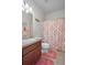 Bathroom with a single vanity and a coral shower curtain at 15439 Stone House Dr, Brooksville, FL 34604