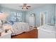 Serene main bedroom with light blue walls, hardwood floors, and a spacious layout at 15439 Stone House Dr, Brooksville, FL 34604