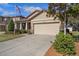 House exterior with a two-car garage and neatly kept landscaping at 15439 Stone House Dr, Brooksville, FL 34604
