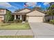 One-story house with a two-car garage and landscaped lawn at 15439 Stone House Dr, Brooksville, FL 34604
