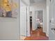 Hallway with light walls, wood floors and doors to bedrooms and bathroom at 15439 Stone House Dr, Brooksville, FL 34604
