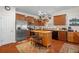 Eat-in kitchen with island, stainless steel appliances, and hardwood floors at 15439 Stone House Dr, Brooksville, FL 34604