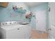 Bright laundry room with washer, dryer, and ample shelving at 15439 Stone House Dr, Brooksville, FL 34604