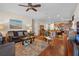 Spacious living room with hardwood floors and a view of the kitchen and dining room at 15439 Stone House Dr, Brooksville, FL 34604