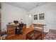 Home office with a wooden desk, comfortable couch and built-in shelves at 15439 Stone House Dr, Brooksville, FL 34604