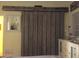 Bedroom with rustic barn door at 1624 Sea Breeze Dr, Tarpon Springs, FL 34689