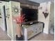 Living room featuring a rustic wood wall and large flat-screen TV at 1624 Sea Breeze Dr, Tarpon Springs, FL 34689
