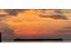 Stunning sunset over calm water with a small island in the distance at 1624 Sea Breeze Dr, Tarpon Springs, FL 34689