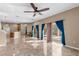 Living room with tile floors, sliding doors, and pool view at 1929 Oswego Dr, Holiday, FL 34691