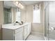 Double vanity bathroom with a walk-in shower and window at 2467 White Ladyfish Rd, Wimauma, FL 33598