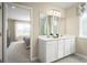 Double vanity bathroom with access to bedroom at 2467 White Ladyfish Rd, Wimauma, FL 33598