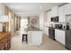 Modern kitchen with white cabinets, granite countertops, and stainless steel appliances at 2467 White Ladyfish Rd, Wimauma, FL 33598
