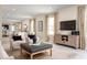 Bright living room with comfy seating, a large TV, and lots of natural light at 2467 White Ladyfish Rd, Wimauma, FL 33598