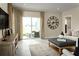 Living area with sliding doors leading to a patio and a large clock on the wall at 2467 White Ladyfish Rd, Wimauma, FL 33598