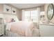 Charming bedroom with a double bed, light pink bedding, and ample natural light at 2473 White Ladyfish Rd, Wimauma, FL 33598