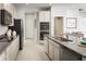 Modern kitchen with granite countertops, stainless steel appliances, and an island at 2473 White Ladyfish Rd, Wimauma, FL 33598