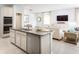 Open concept kitchen with island and view into living room at 2473 White Ladyfish Rd, Wimauma, FL 33598