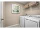 Laundry room with washer, dryer, and overhead shelving for storage at 2473 White Ladyfish Rd, Wimauma, FL 33598