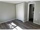 Bedroom with wood-look floors and sliding door closet at 3818 Haven Dr, New Port Richey, FL 34652