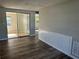 Living area with wood-look floors and sliding doors leading to a sunroom at 3818 Haven Dr, New Port Richey, FL 34652