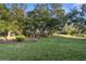 Spacious backyard with lush grass and mature trees at 410 Candlestone Ct, Spring Hill, FL 34609