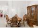 Charming dining area with a round table and wooden hutch at 410 Candlestone Ct, Spring Hill, FL 34609