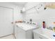 Convenient laundry room with washer, dryer, and utility sink at 410 Candlestone Ct, Spring Hill, FL 34609