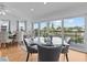 Bright dining room with glass table and chairs overlooking the water at 4225 Carlos Ct, Hernando Beach, FL 34607