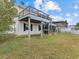 Backyard view of two-story house with deck, spiral stairs and hot tub at 4225 Carlos Ct, Hernando Beach, FL 34607