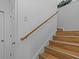 Wood staircase with a simple handrail at 4225 Carlos Ct, Hernando Beach, FL 34607