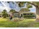 Backyard patio with grill and beautiful landscaping at 4710 Parkdale Ln, New Port Richey, FL 34655