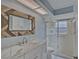 Bathroom features a marble vanity, walk-in shower, and decorative mirror at 4710 Parkdale Ln, New Port Richey, FL 34655