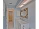 Clean bathroom with a marble vanity and access to hallway at 4710 Parkdale Ln, New Port Richey, FL 34655