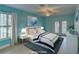 Virtually staged bedroom with light blue walls and private access to outside at 4710 Parkdale Ln, New Port Richey, FL 34655
