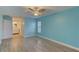 Light blue bedroom with wood-look floors and ensuite bathroom access at 4710 Parkdale Ln, New Port Richey, FL 34655