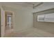 Bright bedroom with carpet flooring and access to hallway at 4710 Parkdale Ln, New Port Richey, FL 34655
