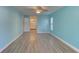 Bright bedroom with light blue walls and wood-look flooring at 4710 Parkdale Ln, New Port Richey, FL 34655