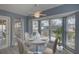 Virtually staged dining area with a charming table and view of the backyard at 4710 Parkdale Ln, New Port Richey, FL 34655