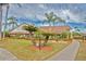 Exterior view of a single-story home with palm trees and landscaping at 4710 Parkdale Ln, New Port Richey, FL 34655