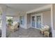 Inviting front porch with wicker furniture, creating a relaxing space at 4710 Parkdale Ln, New Port Richey, FL 34655