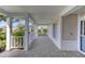 Covered front porch with tiled flooring and white railings at 4710 Parkdale Ln, New Port Richey, FL 34655