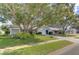 Single story home with lush landscaping and driveway at 4710 Parkdale Ln, New Port Richey, FL 34655